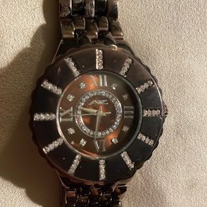 Beautiful coppery brown metal with rhinestones that mark every 5 minutes/ hour